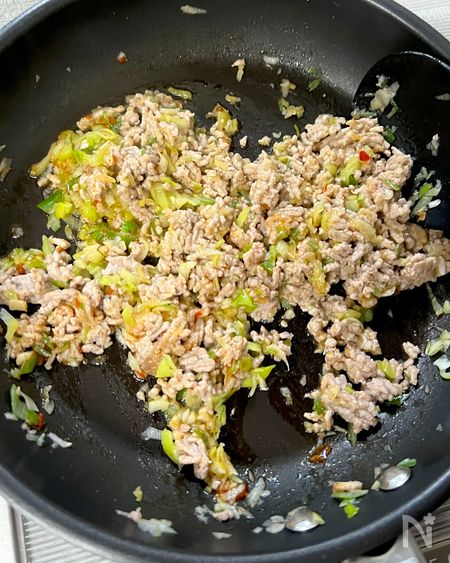 フライパンでひき肉と長ねぎを炒める