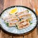 レモンと塩でいただく「ニラとネギの豚肉巻き焼き」